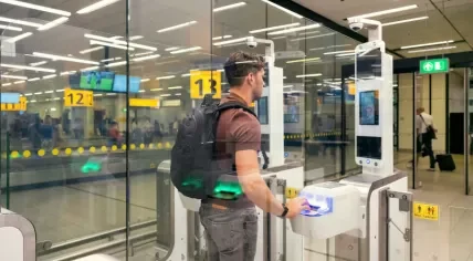 A man going through passport control at Schiphol Airport