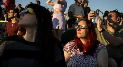 People watching the partial solar eclipse from the rooftop terrace of the NEMO Science Museum in Amsterdam, 12 August 2026